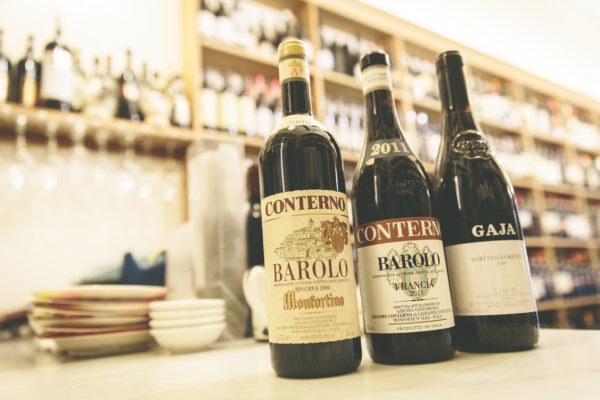 Bottles of Barolo (Conterno, Gaja) on the shop counter
