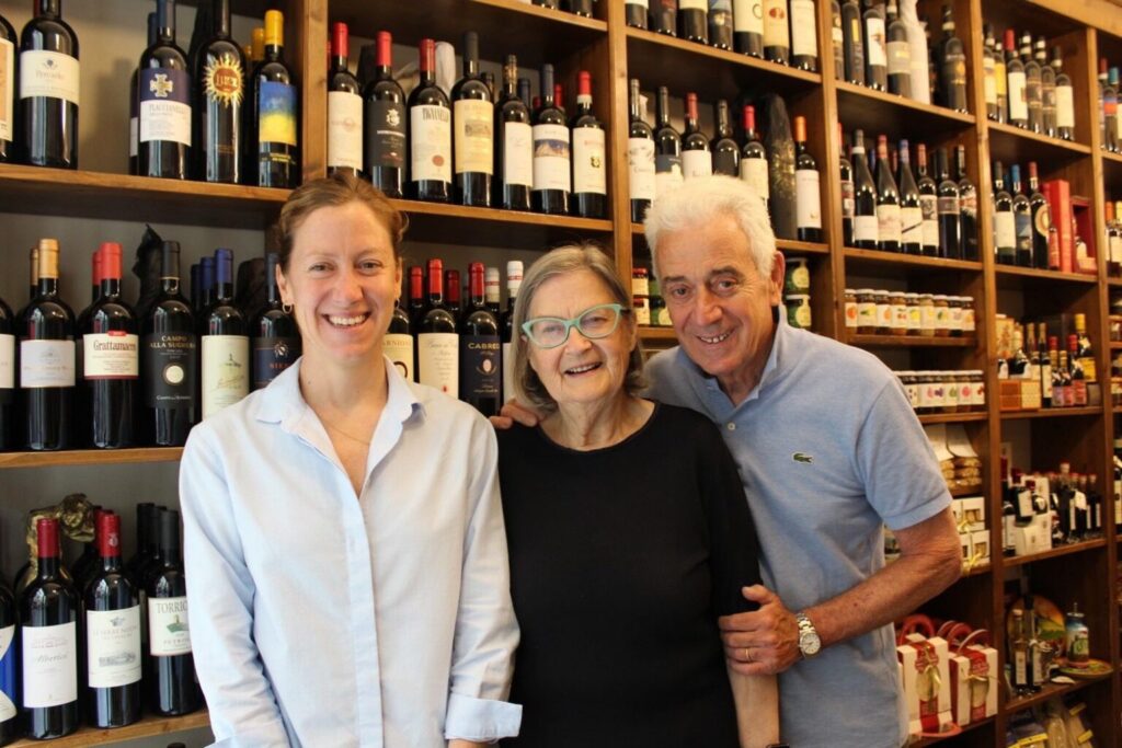 Lucia, Cheryl and Franco Generini together in the shop, surrounded by wine bottles