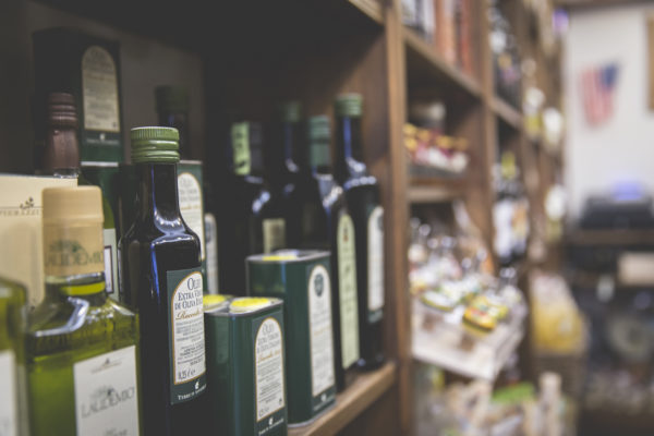 Shelf with extra virgin olive oil bottles